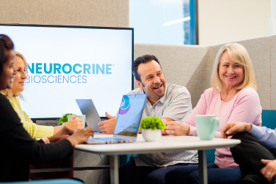 Neurocrine employees conversing in a meeting